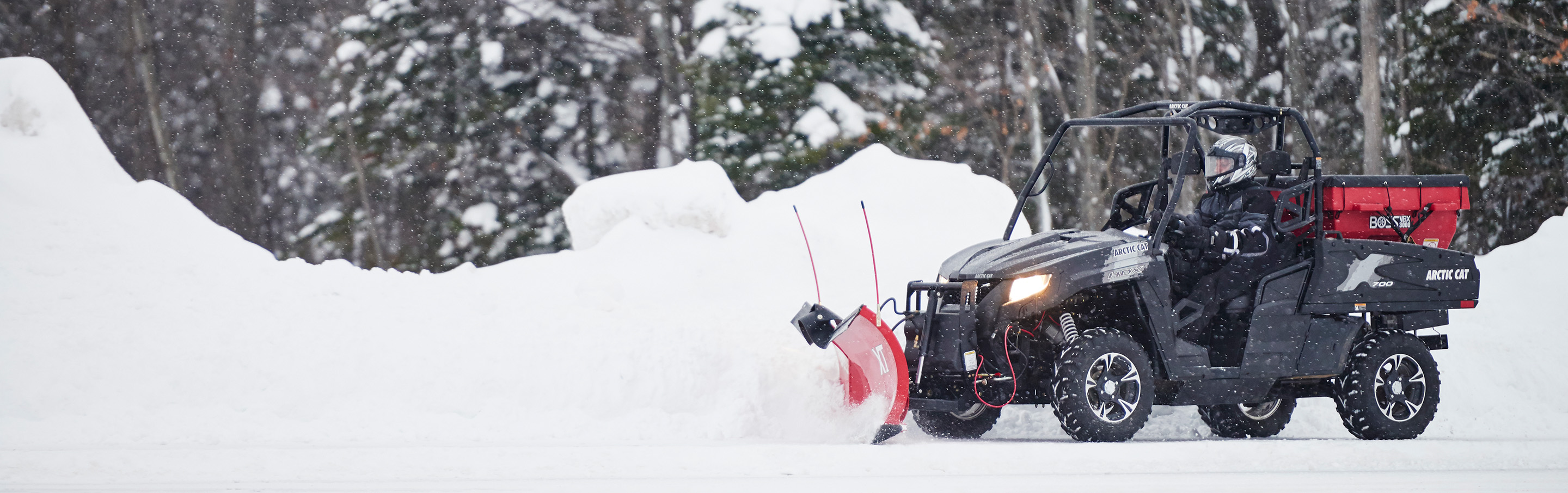UTV plowing snow with a BOSS compact vehicle plow and VBX spreader
