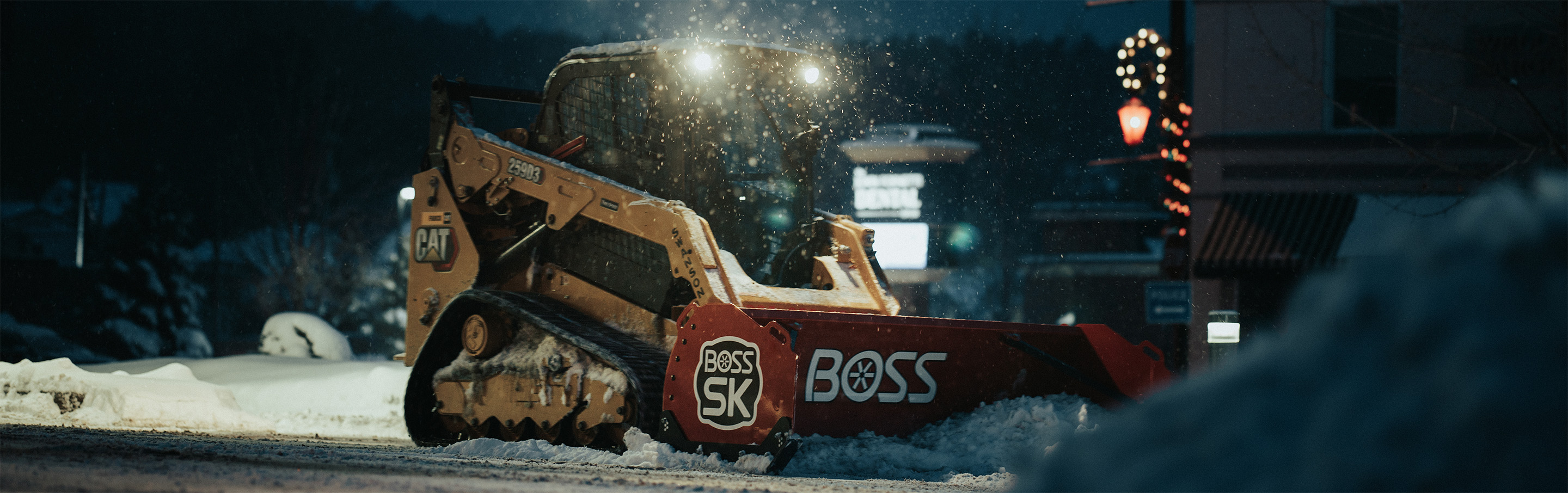 Skid Steer plowing snow with a BOSS SK box plow during the early morning